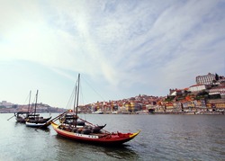 Douro riverside and boats with wine barrels, Porto, Portugal. Vintage picture
