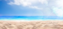 A summer vacation, holiday background of a tropical beach and blue sea and white clouds with sun flare.