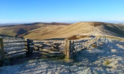 Views of Mozie Law and the fence of the Scottish Border from Windy Gyle on a sunny but frosty winters morning in the Northumberland Cheviot mountains at sunrise, UK.