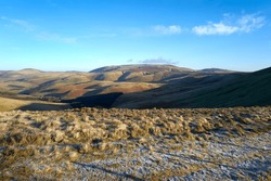 Views of The Cheviot from Windy Rig on a sunny but frosty winters morning in the Northumberland Cheviot mountains at sunrise, UK.