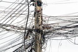 messy electricity wires on the pole, The chaos of cables and wires on an electric pole in Thailand