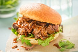 Pulled pork sweet bun with mixed lettuce leaves