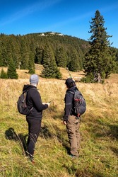 Hikers looking on hill and showing on it. Velky Choc in Slovakia