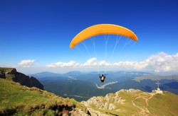 Paraglider prepareing to take off from a mountain
