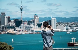 Girl taking photo in front of Auckland