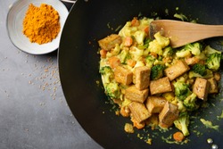 Wok stir fried tofu and vegetables with satay sauce. Top view