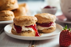 Traditional british scones with clotted cream and strawberry jam for tea time