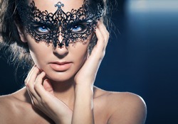 Mask.Nude.Girl.Venice carnival mask Close-up female portrait.Blue eyes. Black background