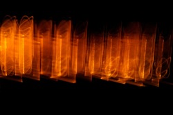 Abstract orange light streaks paint. The long exposure of a photograph taken in a dark environment is the result of the reflection of fire from a solid fuel stove.