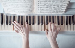 Girl's hands playing piano