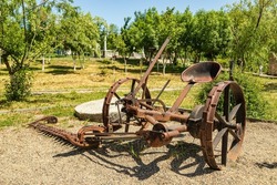 Antique metal mechanical device on wheels for agriculture