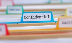 File folders with a tab labeled Confidential