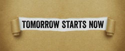 Torn brown paper revealing the words Tomorrow starts now