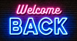 Neon sign on a brick wall - Welcome back
