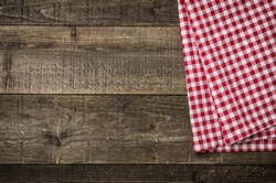 Rustic wooden boards with a red checkered tablecloth