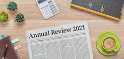 A newspaper on a desk with the headline Annual review 2021