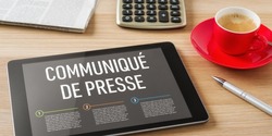 A  tablet with the headline Press Release in french - Communiqué de presse