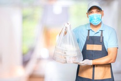 Asian food delivery man wear mask and gloves for cleanliness and hygiene,protect for pandemic and outbreak covid-19 or corona virus, use delivery service in social distancing  and quarantine.  
