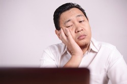 Portrait of Asian man Looked tired upset, depresssed and stressed looking at laptop, sleepy tired stress gesture, bad business pressure, work addict concept