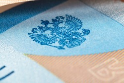 Coat of arms of Russia on the banknote of the Russian Federation with a face value of 2000 rubles. Macro photography. Heraldry.