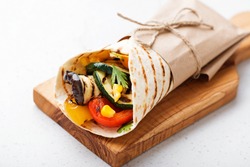 Vegan tortilla wrap, roll with grilled vegetables.