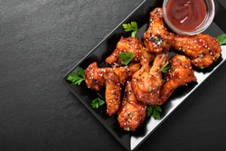 Baked chicken wings with sesame and sauce. Traditional asian recipe. 