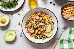Healthy quinoa black bean salad with mango and avocado. Perfect for spring, summer, fall or winter. Gray stone background, top view. 