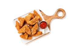 Delicious crispy fried breaded chicken breast strips with ketchup. Isolated on white background. top view