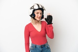Young caucasian woman with a motorcycle helmet isolated on white background saluting with hand with happy expression