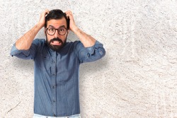 frustrated Young hipster man over textured background 