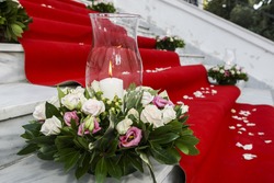 Wedding red carpet with white candles in church stairs
