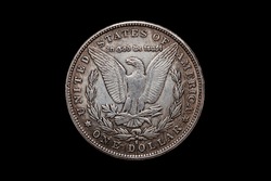 USA One Dollar Morgan Silver Coin replica dated 1880 with an image of a spread eagle on the reverse cut out and isolated on a black background, stock photo image