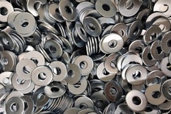 Washers for the bolt. Texture. Many washers for bolts and screws. Background for wallpaper. Shim. Spacer.