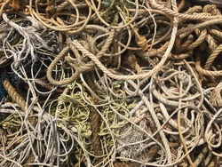 Many sizes of hemp rope entangle together on the floor.