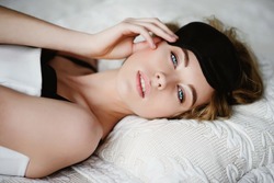 Portrait of a beautiful blonde girl with a mask for sleeping, lifestyle