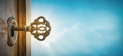 Old key in keyhole on sky background with sun ray . Concept, symbol and Idea for History, business, security, religion background.