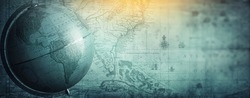 Ancient globe on the old map background. Selective focus. Retro style. Science, education, travel, vintage background. History and geography team. Blue tinted.