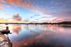 Sunset at Bensville Australia.   Boats and yachts and cloud reflections in the late afternoon.