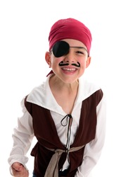 A happy young  boy wearing a pirate costume.  White background.