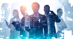 Business success and partnership concept. Silhouettes of young business people with double exposure of blurry abstract night city panorama. Toned image.
