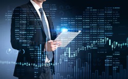 Businessman trader in suit using tablet with business report hologram. Business and financial success concept. double exposure. Forex Chart