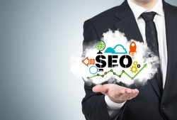 A manager is holding a cloud with the SEO cloud.