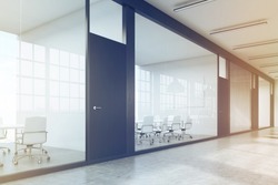Side view of a row of meeting rooms in a long corridor. Glass walls, black doors. Concept of communication. 3d rendering. Toned image