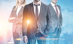 Close up of three unrecognizable business people standing together against a blue city panorama. Toned image double exposure
