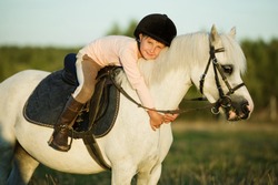 Girl riding a horse on nature