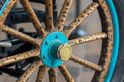 Vintage wooden spoke car wheel. Close-up of wood spokes on a classic motor vehicle. History of automobiles.