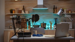 Podcast home studio in the kitchen with professional brodcasting gear. Influencer recording social media content with production microphone. Digital web internet streaming station