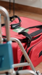 Close up of bag with medical equipment and wheelchair in nursing home. Healthcare handbag with tools for recovery and healing treatment. Transportation and rehabilitation objects
