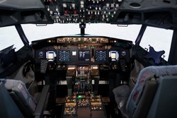 Empty airplane cockpit with electronic flying navigation panel, control command with buttons and lever on dashboard. No people in aircraft cabin to throttle engine and takeoff.