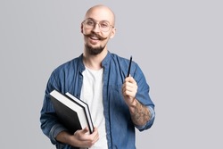 Close up photo handsome he him his guy pen hands arms hold notebook making notes carefully author have inspiration clever smart isolated grey background.